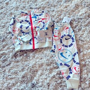 NWT Nike 12 months matching sweatpants and zip up jacket.